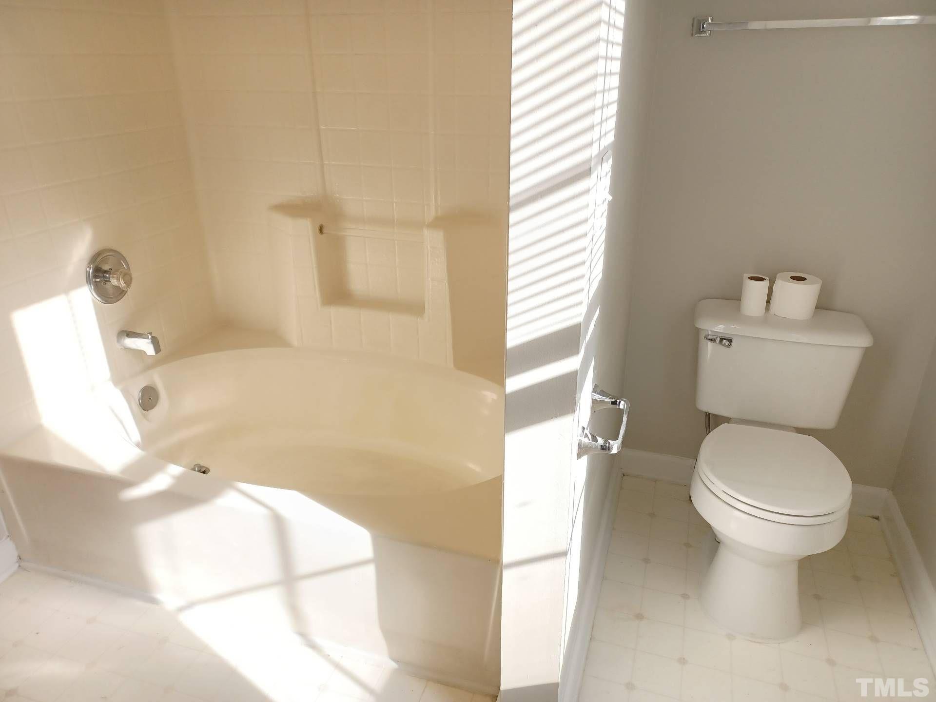 208 Lindell Drive Apex, NC 27539 - Photo 23 of 27 a bathroom with a toilet and a bathtub