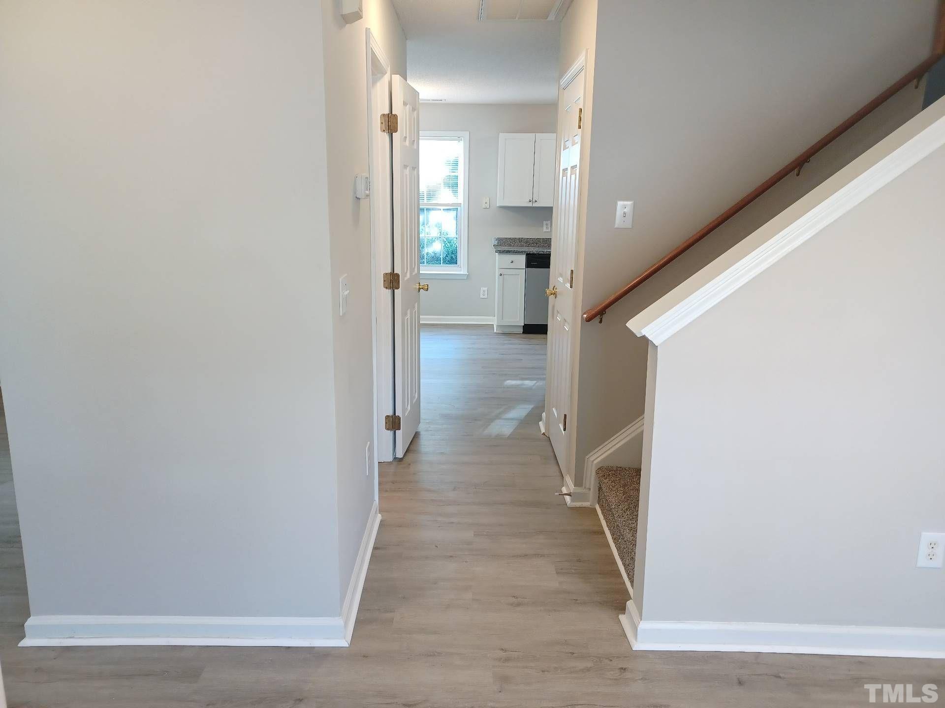 208 Lindell Drive Apex, NC 27539 - Photo 3 of 27 a view of a hallway view with wooden floor and staircase