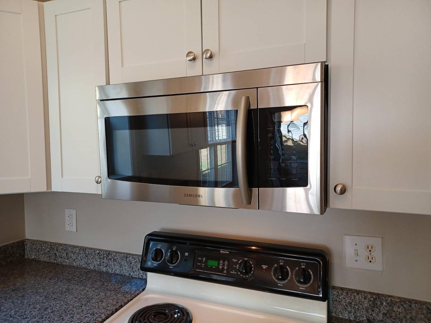208 Lindell Drive Apex, NC 27539 - Photo 10 of 27 a kitchen with a stove and a microwave