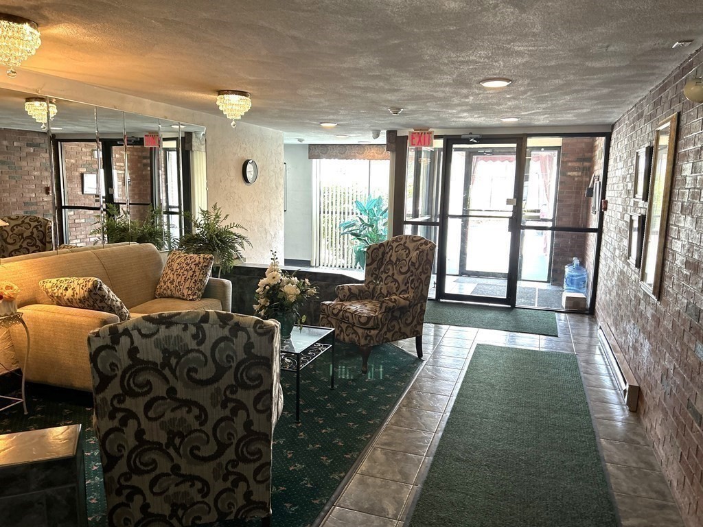 111 Devir Street, Unit 402 Malden, MA 02148 - Photo 16 of 19 a living room with furniture large windows and wooden floor