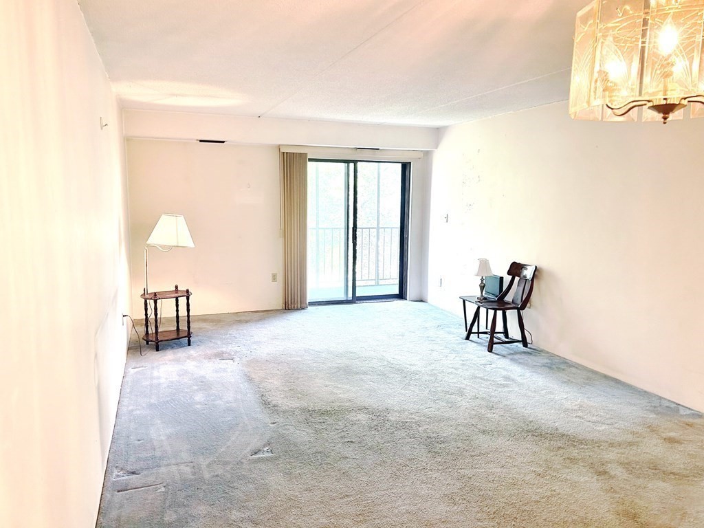 111 Devir Street, Unit 402 Malden, MA 02148 - Photo 3 of 19 a furnished livingroom with a window and a chair