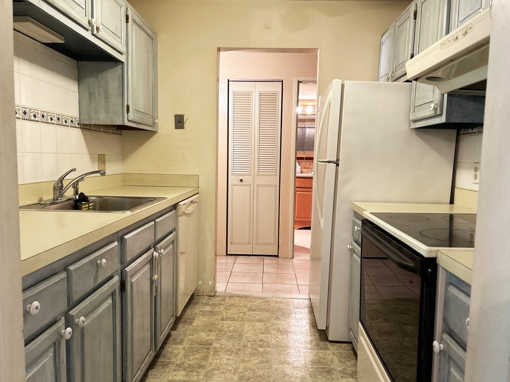 111 Devir Street, Unit 402 Malden, MA 02148 - Photo 5 of 19 a kitchen with a sink stove and refrigerator