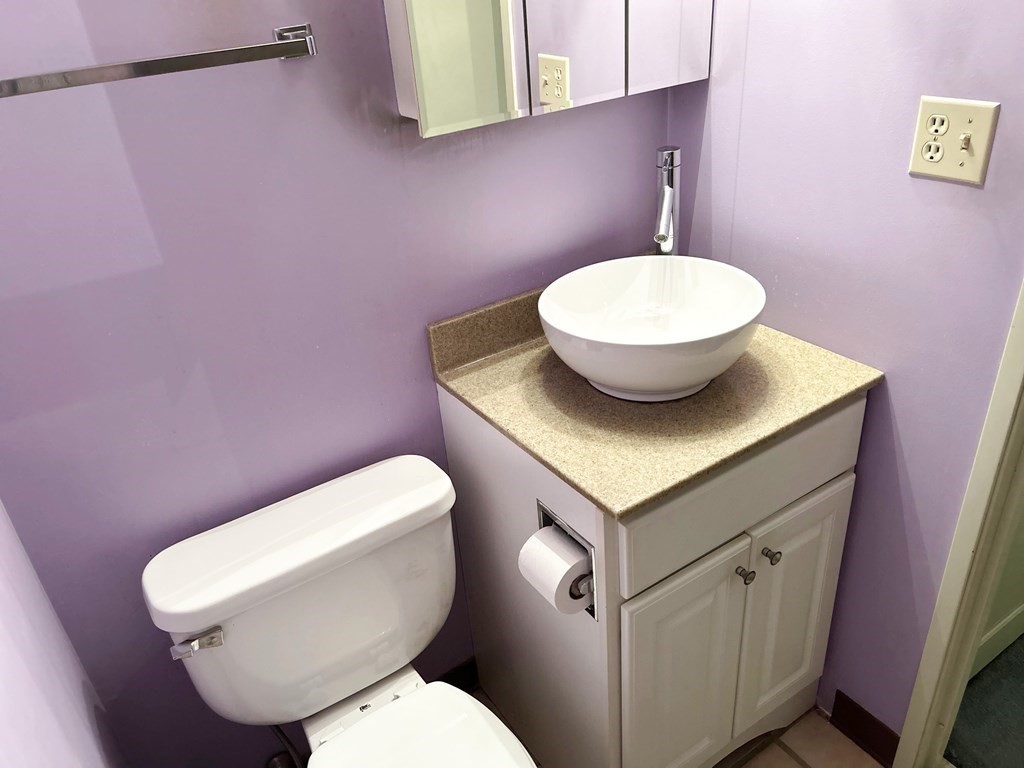 111 Devir Street, Unit 402 Malden, MA 02148 - Photo 9 of 19 a bathroom with a granite countertop toilet sink and mirror