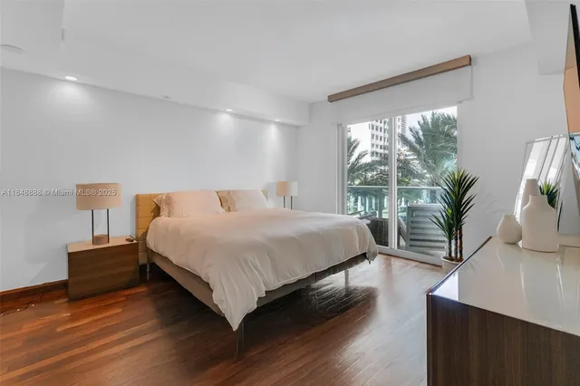 a spacious bedroom with a bed and a potted plant