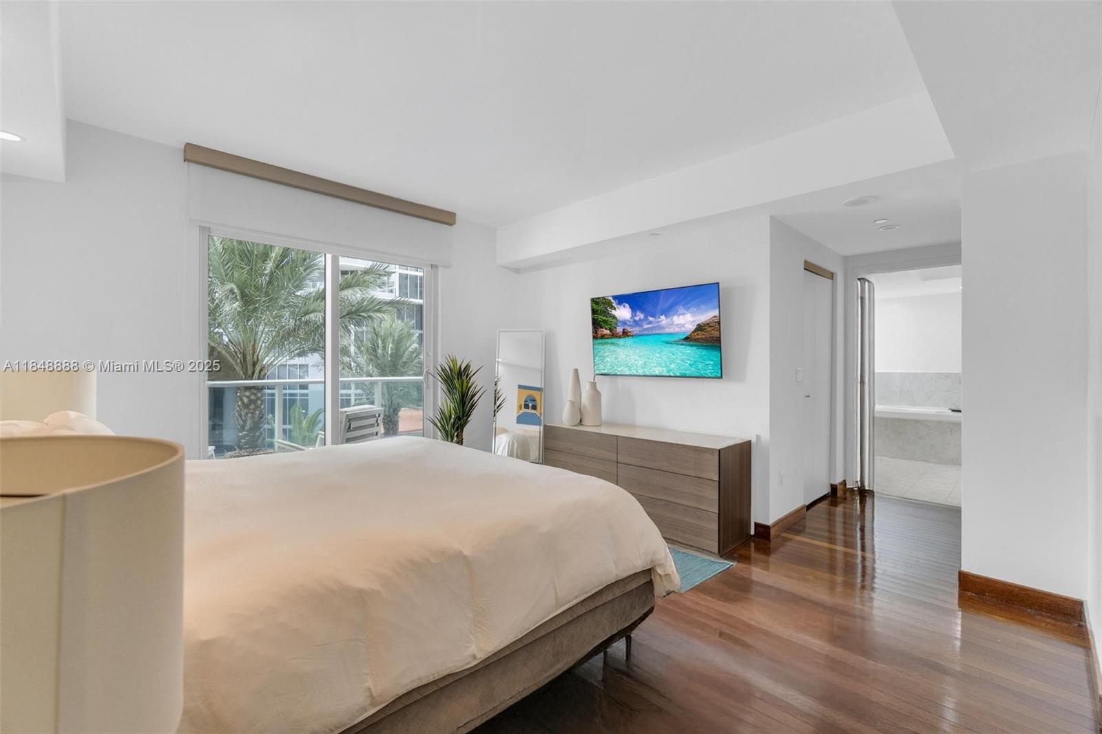 1331 Brickell Bay Drive, Unit 208 Miami, FL 33131 - Photo 12 of 29 a bedroom with a bed and a flat screen tv