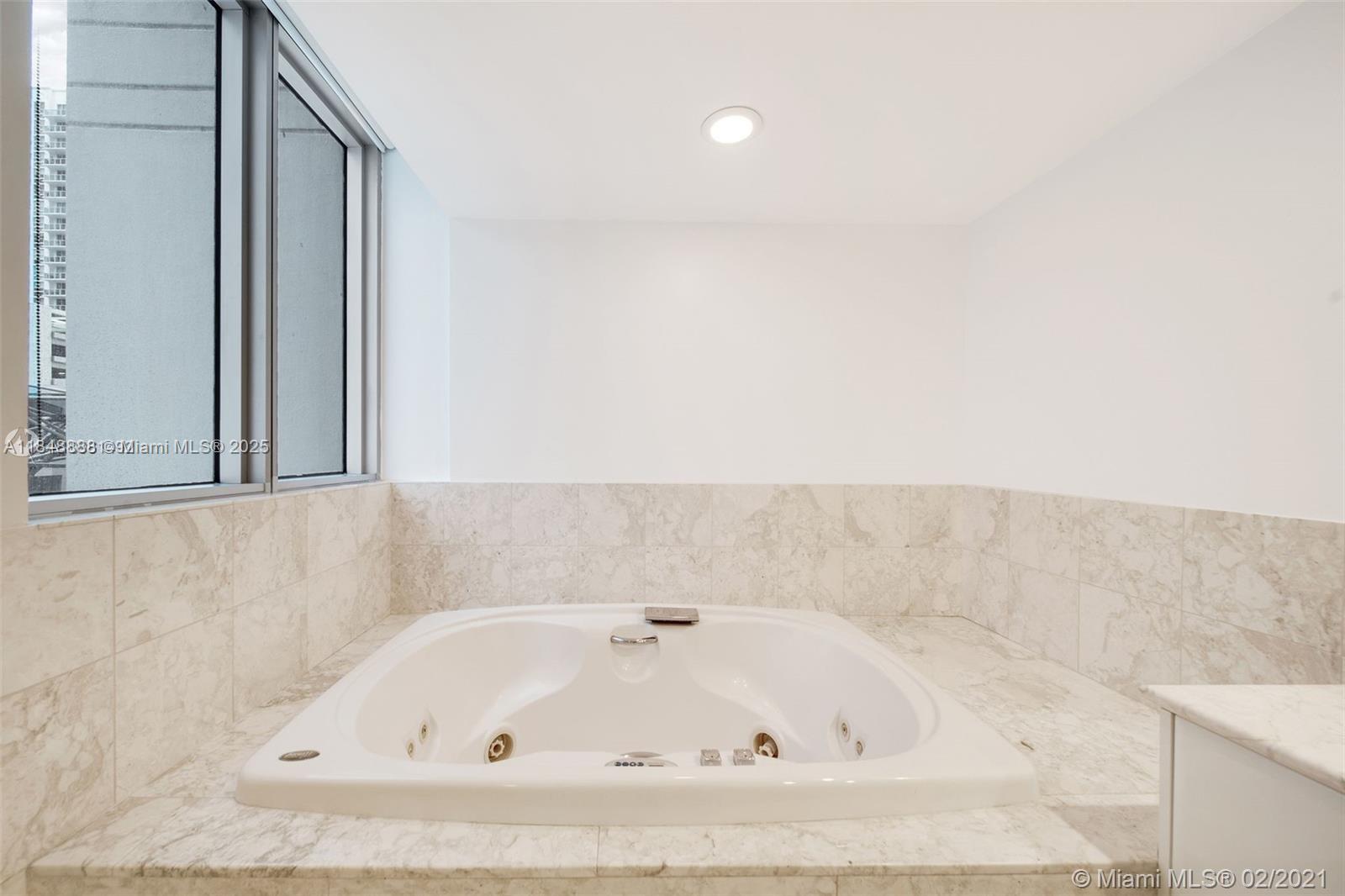 1331 Brickell Bay Drive, Unit 208 Miami, FL 33131 - Photo 14 of 29 a bathroom with bathtub and shower