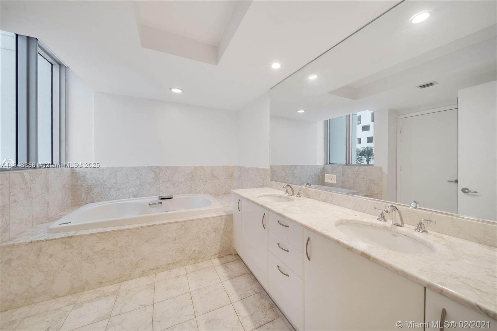 1331 Brickell Bay Drive, Unit 208 Miami, FL 33131 - Photo 16 of 29 a spacious bathroom with a double vanity sink mirror and bathtub