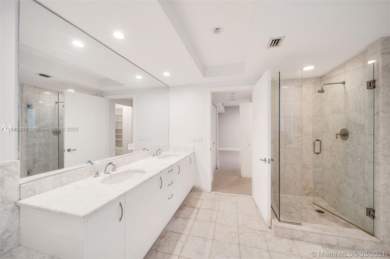 1331 Brickell Bay Drive, Unit 208 Miami, FL 33131 - Photo 17 of 29 a large bathroom with a double vanity sink mirror and shower