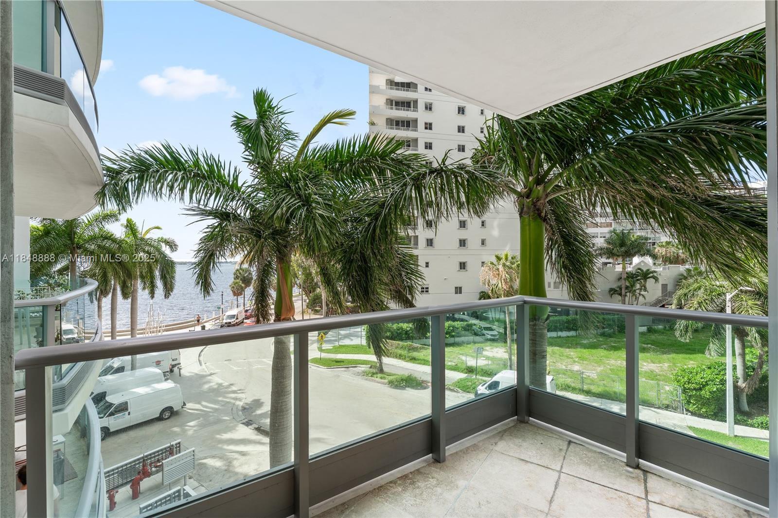 1331 Brickell Bay Drive, Unit 208 Miami, FL 33131 - Photo 25 of 29 a view of a palm plant from a window