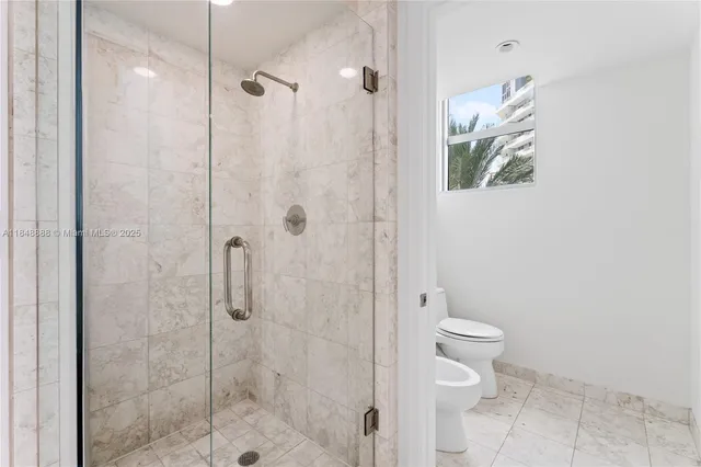 a bathroom with a shower a toilet and a shower