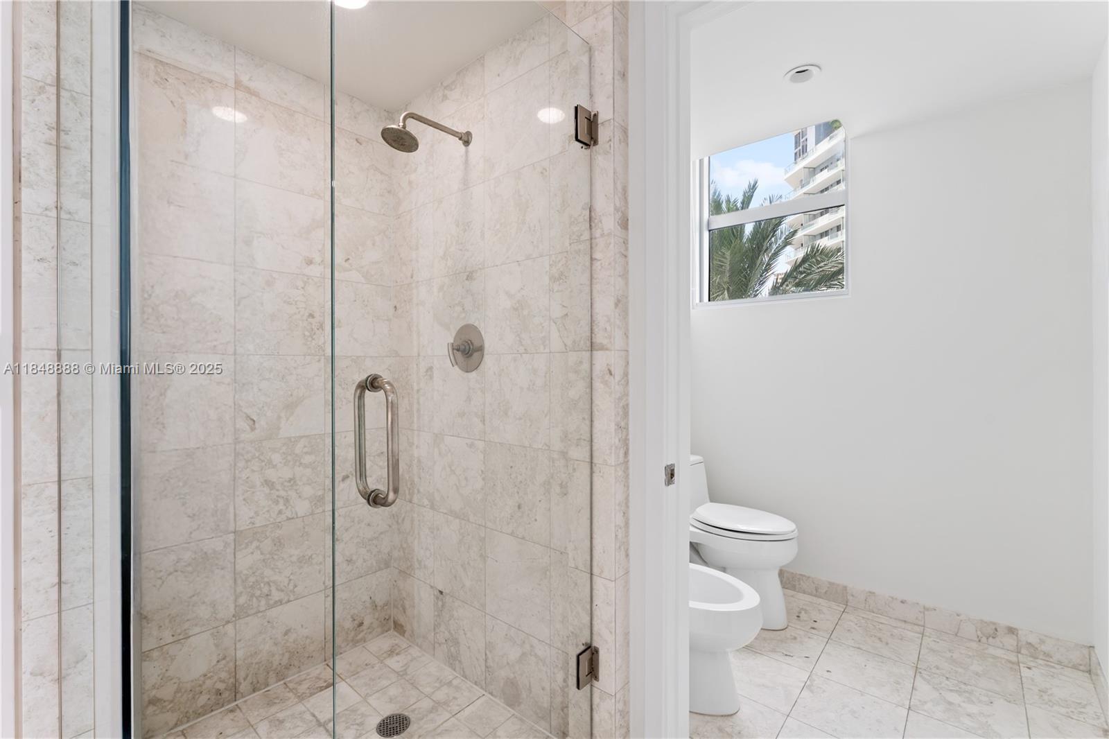 1331 Brickell Bay Drive, Unit 208 Miami, FL 33131 - Photo 26 of 29 a bathroom with a shower a toilet and a shower