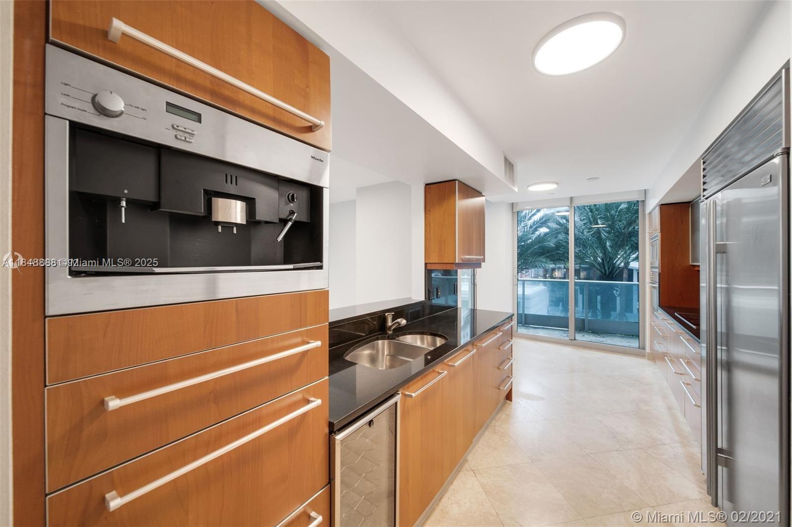 1331 Brickell Bay Drive, Unit 208 Miami, FL 33131 - Photo 5 of 29 a living room with stainless steel appliances kitchen island granite countertop a refrigerator and a sink