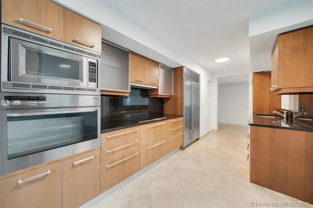 a kitchen with stainless steel appliances granite countertop a stove and a microwave