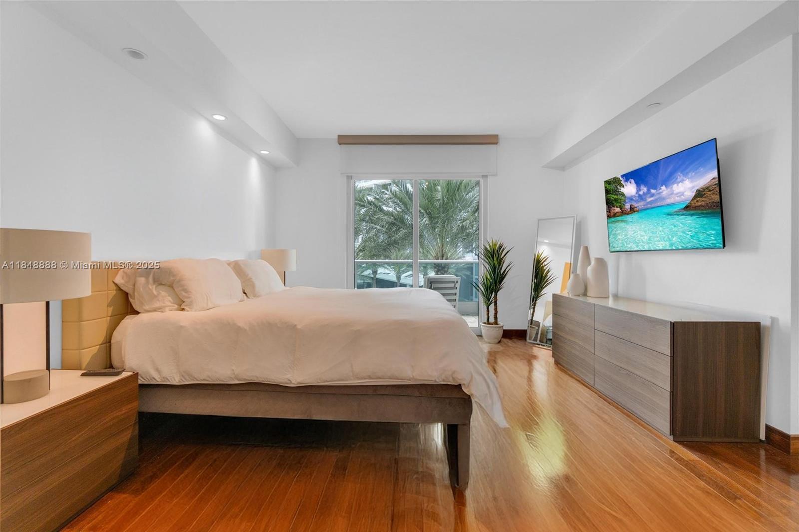 1331 Brickell Bay Drive, Unit 208 Miami, FL 33131 - Photo 10 of 29 a bed room with a bed and a flat screen tv