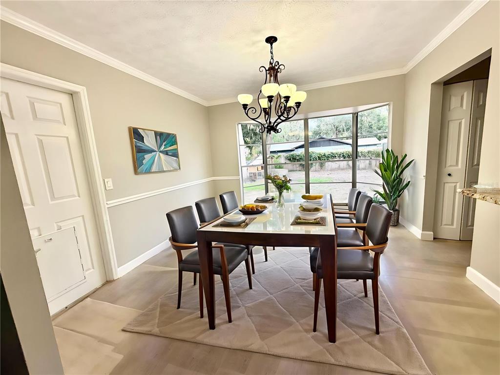 502 Oakhurst Street Brandon, FL 33511 - Photo 12 of 40 a view of a dining room with furniture wooden floor and chandelier