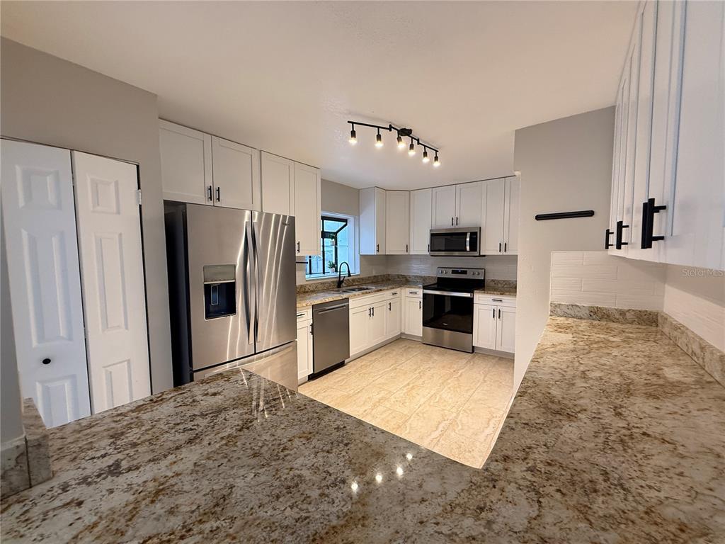 502 Oakhurst Street Brandon, FL 33511 - Photo 15 of 40 a large kitchen with cabinets and stainless steel appliances