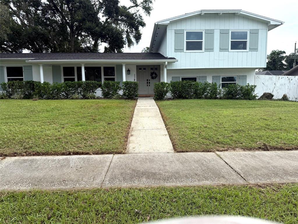 502 Oakhurst Street Brandon, FL 33511 - Photo 2 of 40 a front view of a house with a yard