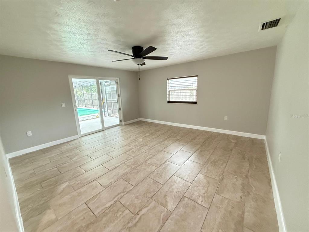 502 Oakhurst Street Brandon, FL 33511 - Photo 22 of 40 an empty room with windows and fan