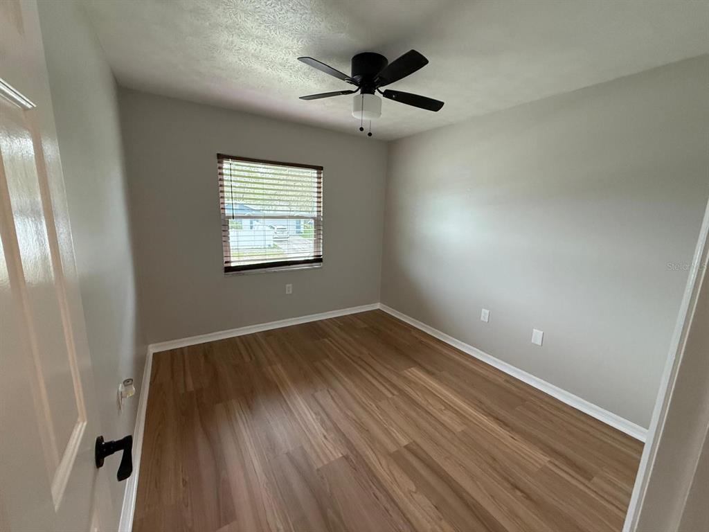 502 Oakhurst Street Brandon, FL 33511 - Photo 26 of 40 an empty room with wooden floor and windows