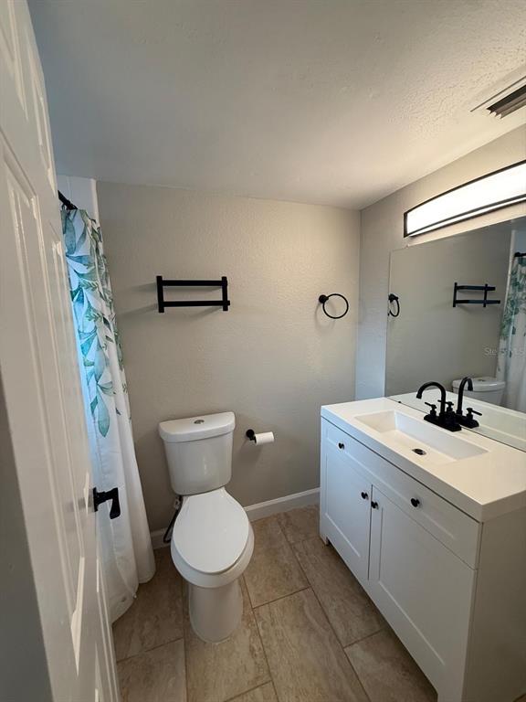 502 Oakhurst Street Brandon, FL 33511 - Photo 27 of 40 a bathroom with a toilet a sink and a mirror