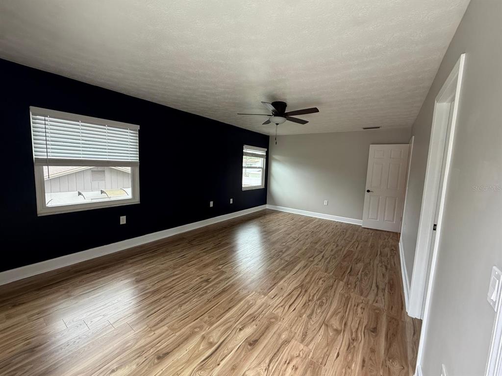 502 Oakhurst Street Brandon, FL 33511 - Photo 29 of 40 a view of an empty room with wooden floor and a window
