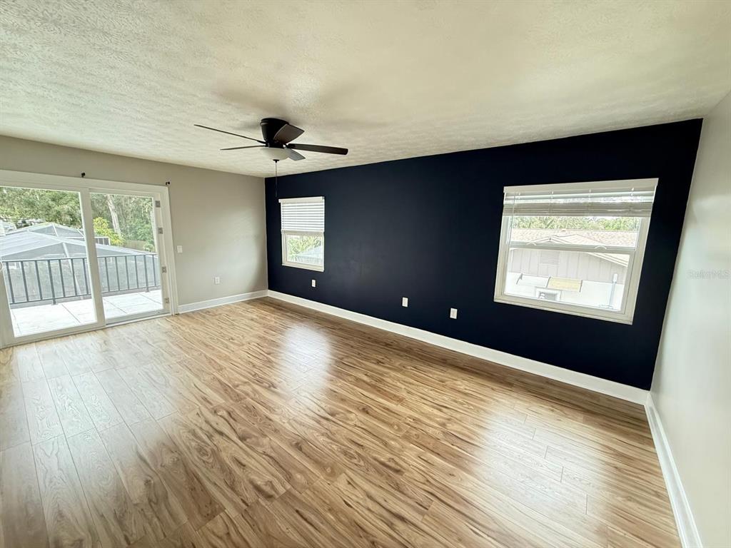 502 Oakhurst Street Brandon, FL 33511 - Photo 30 of 40 a view of an empty room with wooden floor and a window