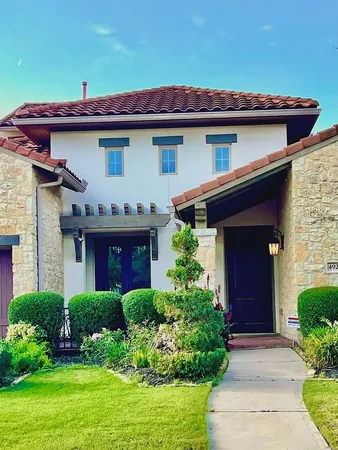a front view of a house with garden
