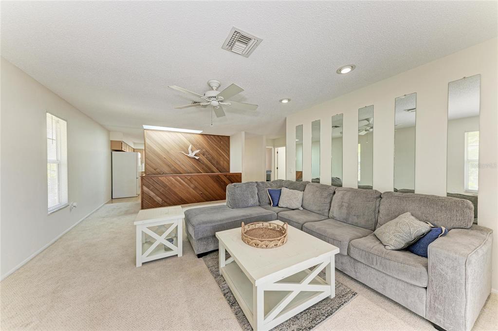 517 Spring Avenue Anna Maria, FL 34216 - Photo 11 of 50 a living room with furniture and a chandelier