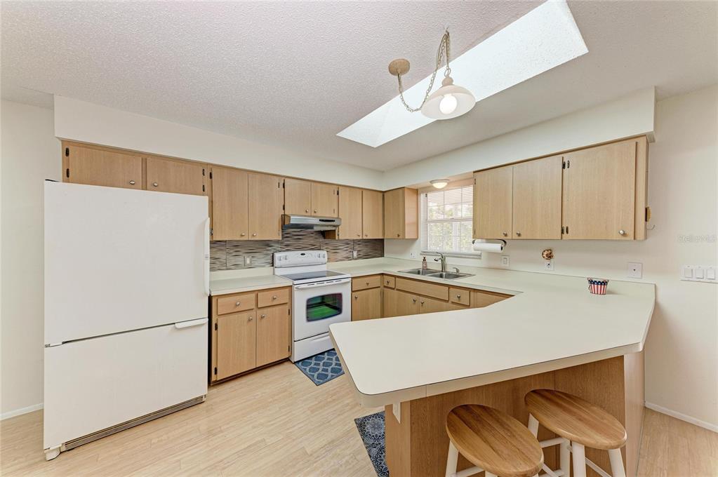 517 Spring Avenue Anna Maria, FL 34216 - Photo 13 of 50 a kitchen with a sink a stove and refrigerator