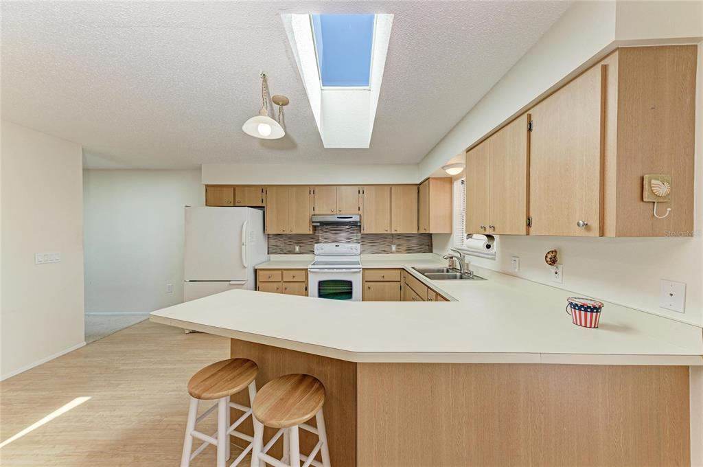 517 Spring Avenue Anna Maria, FL 34216 - Photo 14 of 50 a kitchen with a sink a stove and cabinets