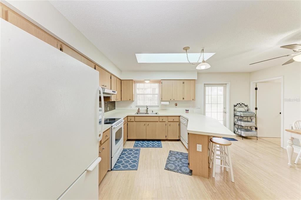 517 Spring Avenue Anna Maria, FL 34216 - Photo 16 of 50 a large white kitchen with a large window