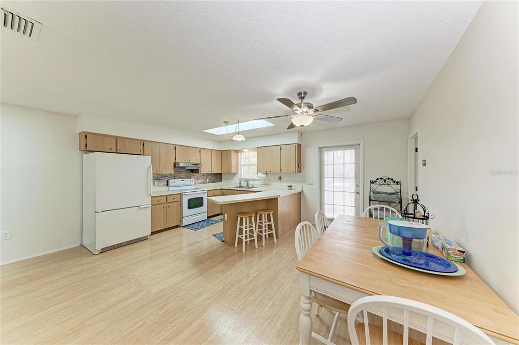 517 Spring Avenue Anna Maria, FL 34216 - Photo 18 of 50 a kitchen with a table and chairs