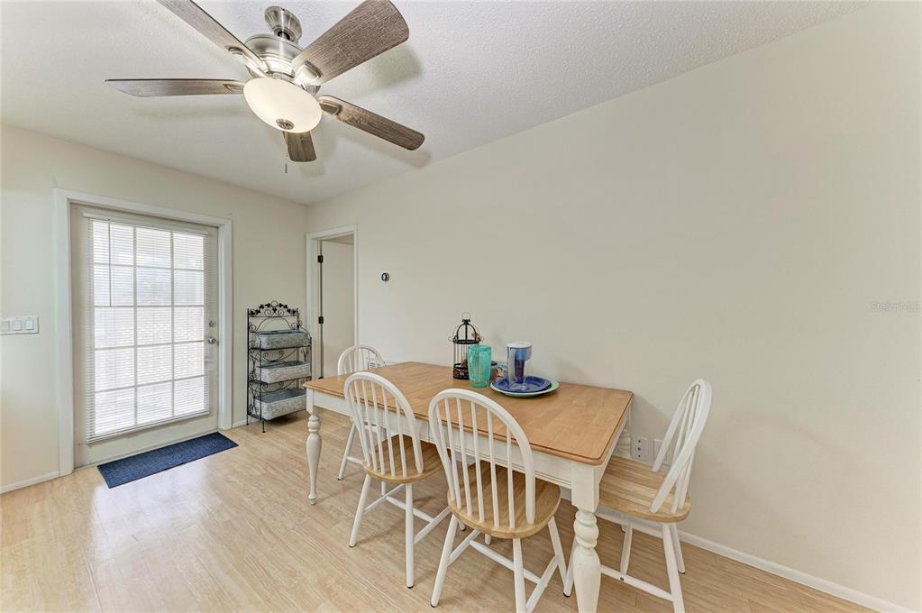 517 Spring Avenue Anna Maria, FL 34216 - Photo 19 of 50 a view of a dining room with furniture and wooden floor