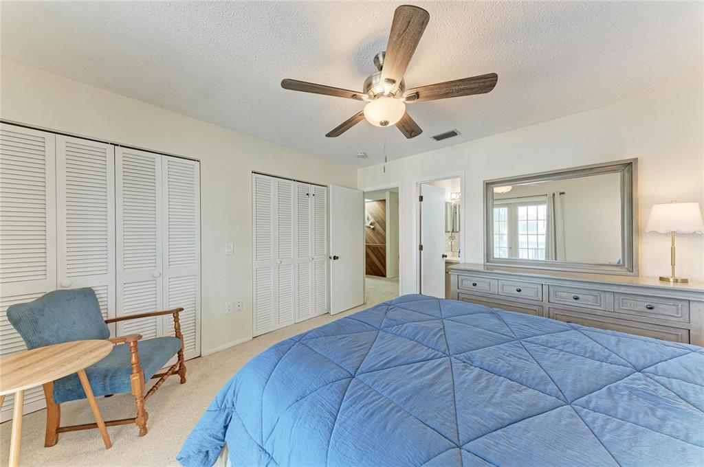 517 Spring Avenue Anna Maria, FL 34216 - Photo 21 of 50 a bedroom with a bed and a chandelier