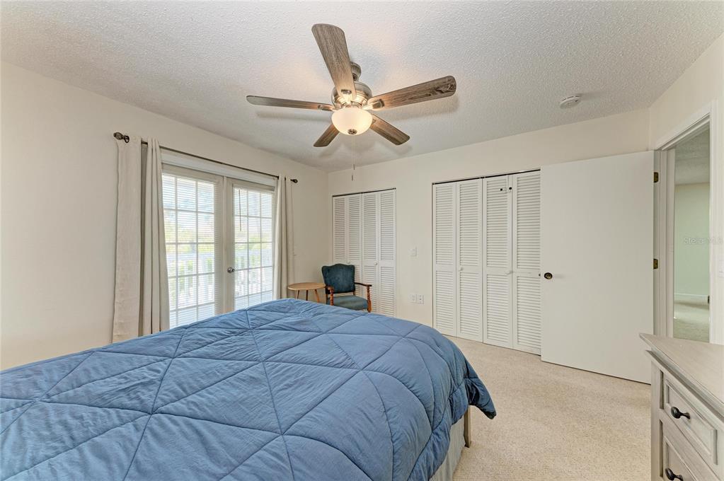 517 Spring Avenue Anna Maria, FL 34216 - Photo 22 of 50 a bedroom with a bed and a window