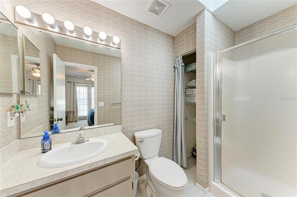 517 Spring Avenue Anna Maria, FL 34216 - Photo 23 of 50 a bathroom with a sink a toilet a mirror and shower