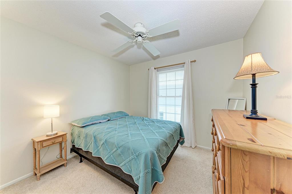517 Spring Avenue Anna Maria, FL 34216 - Photo 24 of 50 a bedroom with a bed and a window