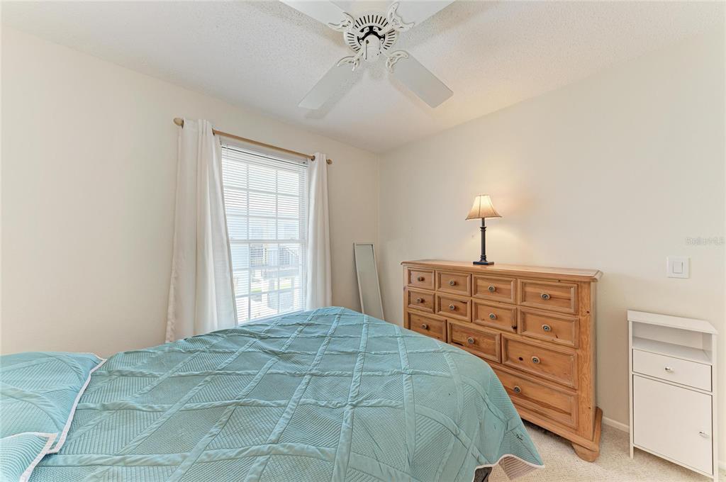 517 Spring Avenue Anna Maria, FL 34216 - Photo 26 of 50 a bedroom with a bed and a dresser
