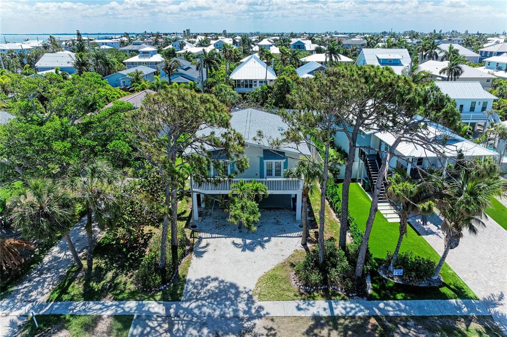 517 Spring Avenue Anna Maria, FL 34216 - Photo 3 of 50 an aerial view of a house with a yard and lake view