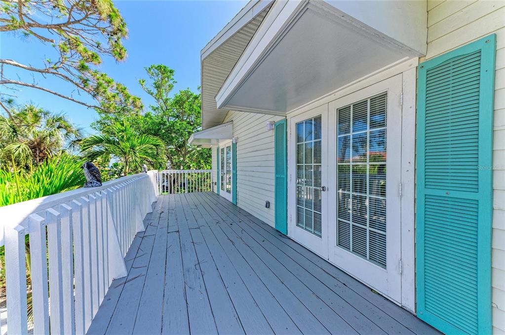 517 Spring Avenue Anna Maria, FL 34216 - Photo 31 of 50 a view of deck with a large window and wooden floor