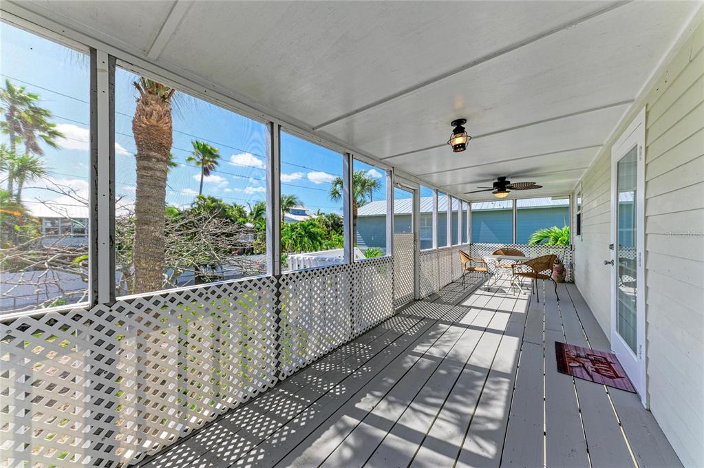 517 Spring Avenue Anna Maria, FL 34216 - Photo 32 of 50 a view of a porch with wooden floor and outdoor space