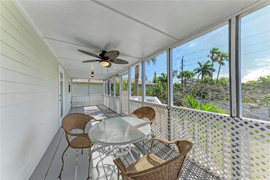 517 Spring Avenue Anna Maria, FL 34216 - Photo 34 of 50 a dining room with furniture and wooden floor
