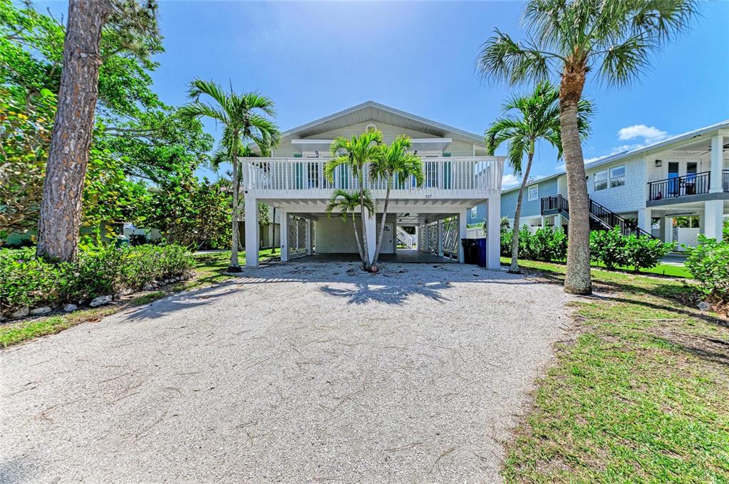 517 Spring Avenue Anna Maria, FL 34216 - Photo 50 of 50 a front view of a house with yard and green space