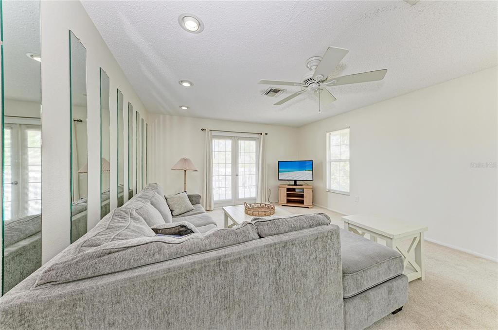 517 Spring Avenue Anna Maria, FL 34216 - Photo 10 of 50 a living room with furniture and a chandelier