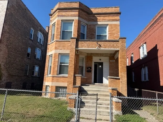 front view of a brick house with a large window