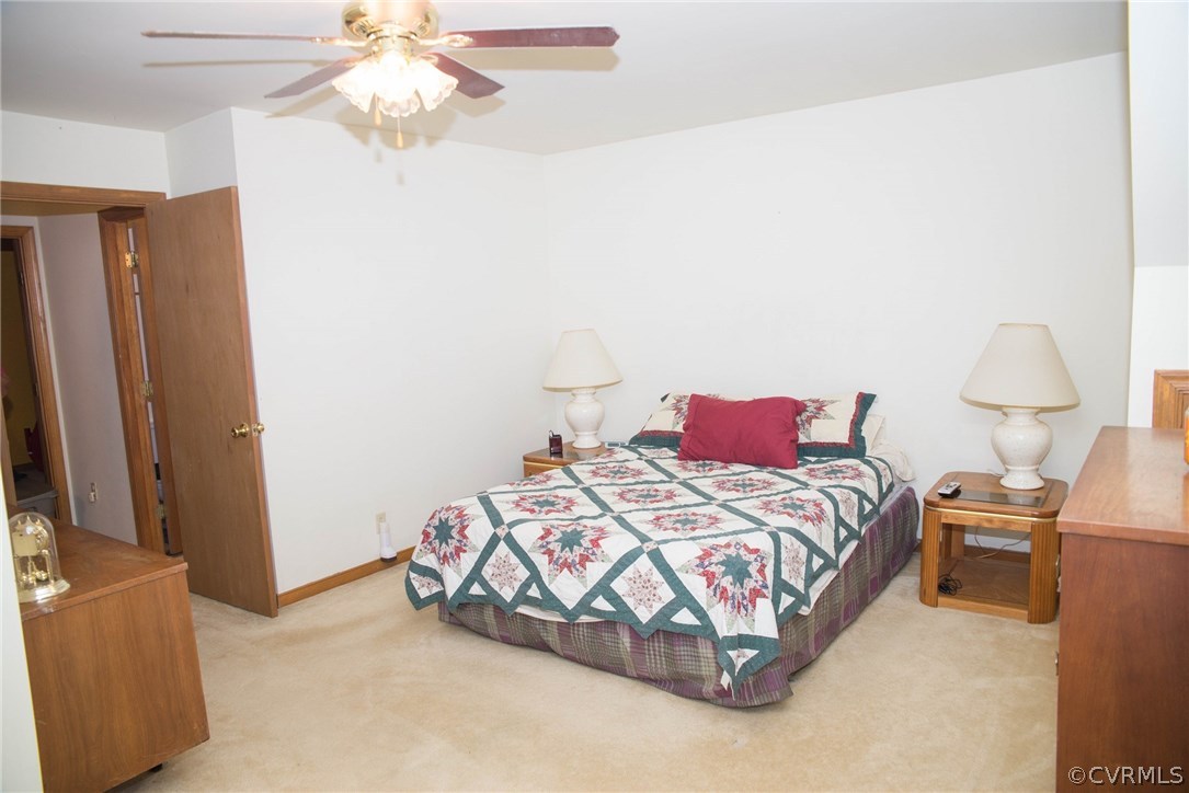 3206 Roland View Terrace Chester, VA 23831 - Photo 23 of 29 a bedroom with a bed and a chandelier
