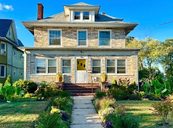 a front view of a house with a yard outdoor seating and garden