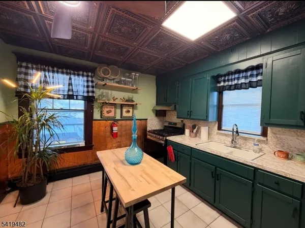 a kitchen with a sink a counter space and a window