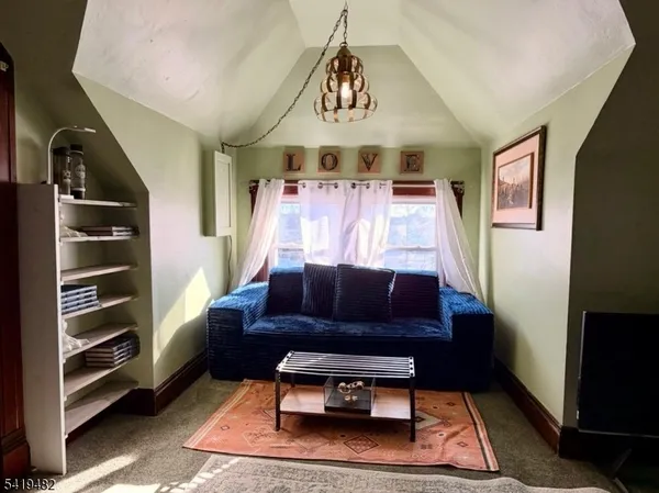 a living room with furniture a rug and a window