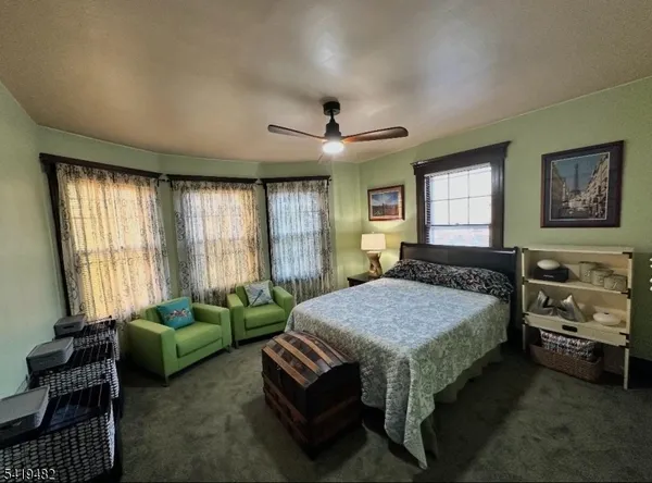 a spacious bedroom with a bed and a couch